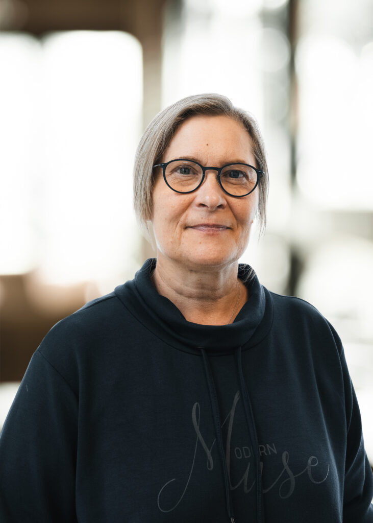 Kvinde i mørk trøje, indendørs